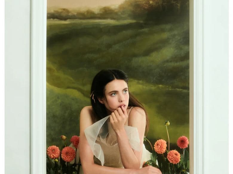 Framed landscape painting built as a set piece with a figure emerging from it, styled by Lauren Bahr for Margaret Qualley in Paper Magazine