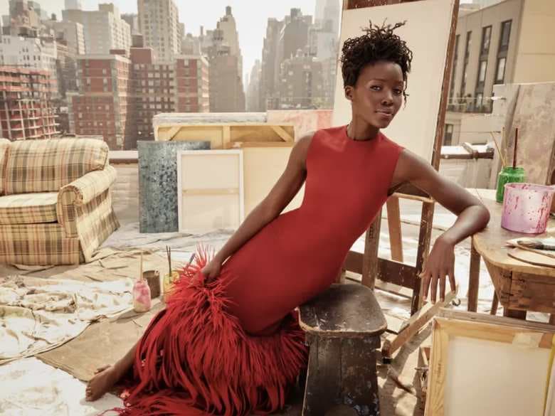 Rooftop set dressed with a striped sofa, wooden chairs, easels and drop cloths above the Manhattan skyline, styled by Jack Flanagan