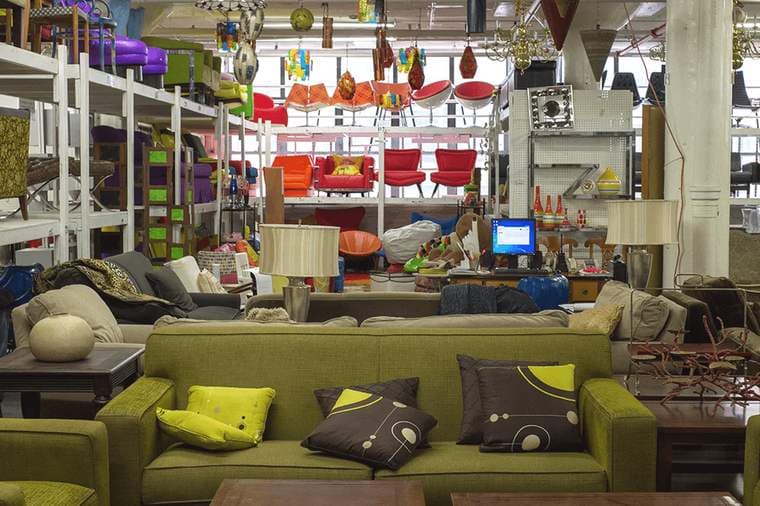 The floor at Eclectic Props, stacked with furniture and lighting